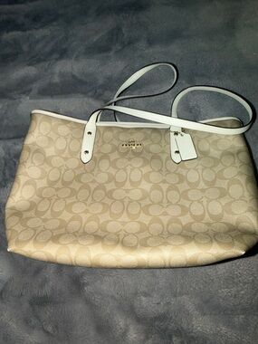 Coach Beige Signature Canvas Tote with White Trim 11.5”X10” has a hang tag.